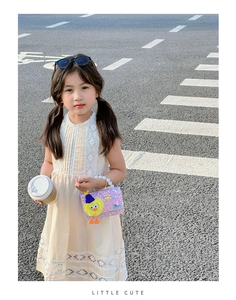 Detail of sequin girl's crossbody bag with pearl handle and floral cute decoration