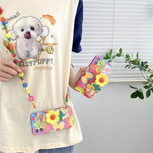 Close-up of iPhone case featuring 3D sunflower and colorful beaded crossbody strap