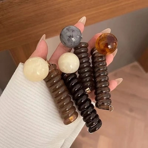 Spiral telephone wire hair ties with large round beads in multiple elegant colors