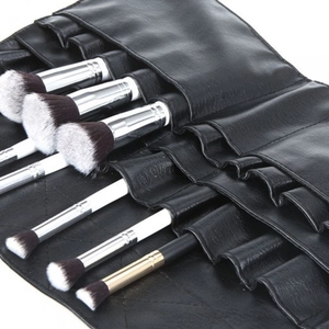 Close-up of black PU leather makeup brush organizer with various brushes in slots