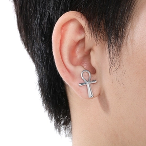 Detail of silver Ankh cross stud earring worn on ear showing polished stainless steel finish