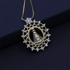 Detailed close-up of a gold heart pendant with Virgin Mary and blue zircon stones