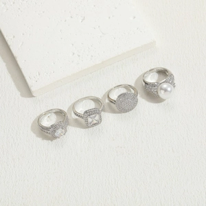 Detailed view of four S925 silver rings featuring pearls and sparkling zircon stones