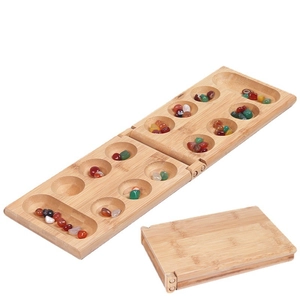 Folding wooden Mancala board game set with colorful gemstone pieces on white background