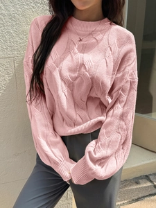 Women's pink cable knit sweater with a turtleneck design and elegant ribbed cuffs
