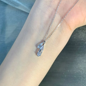 Detail of silver S925 necklace with clear water drop and marquise cubic zirconia on skin