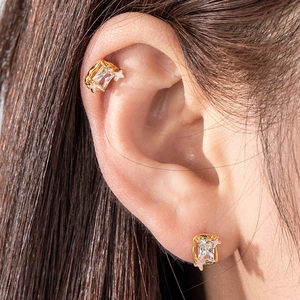 Gold star geometric cartilage stud earrings featuring rectangular clear zircon gemstones