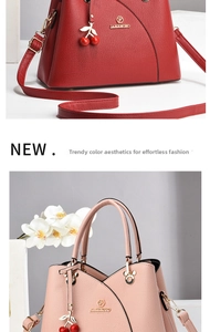 Close-up of litchi grain leather handbags in red and pink with cherry charms