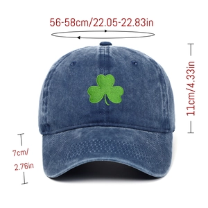 Detailed view of washed denim baseball cap with clover embroidery and sizing dimensions