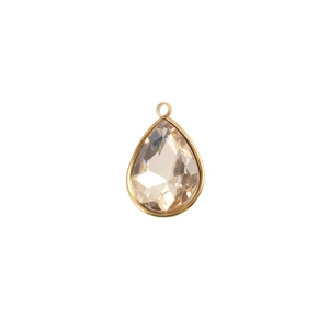 Macro shot of a faceted champagne teardrop birthstone crystal with gold metal edging