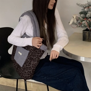 Leopard print plush tote bag with grey fleece pocket and shoulder strap detail