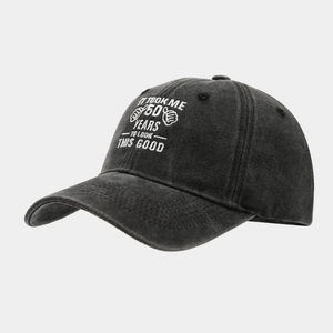 Detail of dark grey washed cotton baseball cap with 50th birthday embroidery text