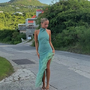 Mint green halter neck backless maxi dress with feather hem detail for party and vacation