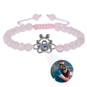 Detail of pink beaded bracelet with silver paw pendant featuring custom photo projection