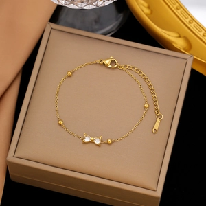Elegant gold bow charm bracelet with cubic zirconia set in premium stainless steel