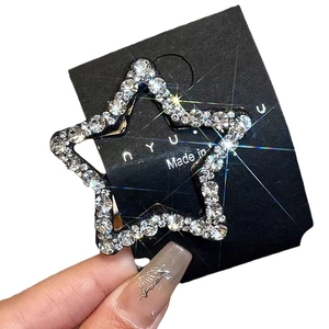 Sparkling pentagram star hair clip with rhinestones on a black display card