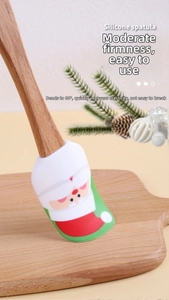 Flexible silicone Christmas spatula with wooden handle and Santa Claus print detail
