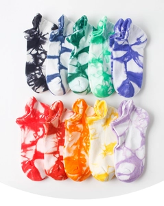 Flat lay of ten pairs of colorful tie-dye ankle socks with low-cut heel tabs in various vibrant hues