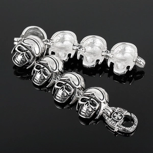 Macro detail of silver skull link bracelet with vintage goggles and textured punk finish