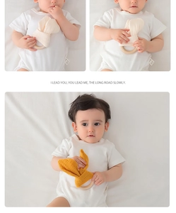 Close-up of soft cotton gauze bunny ears teething toy with a natural wood ring for babies