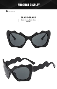 Detail view of stylish wavy frame sunglasses in black with Y2K cat-eye design