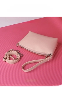 Detailed view of pink lychee grain faux leather handbag with detachable shoulder strap