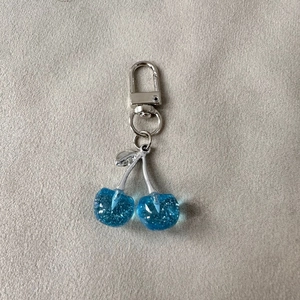 Glitter blue cherry keychain with transparent resin fruit and silver metal D-ring clip
