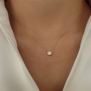 Minimalist gold stainless steel necklace with circular birthstone pendant on model