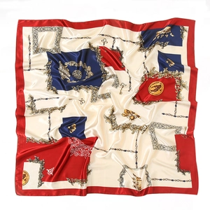 Detailed view of luxury red and blue square silk scarf with golden chain and key patterns