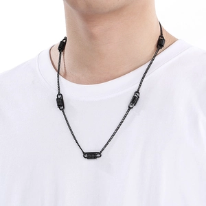 Detailed close-up of a men's black stainless steel necklace with a unique spring pendant