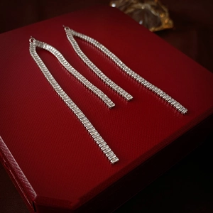 Elegant long cubic zirconia tassel drop earrings on luxury red velvet gift box