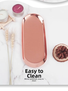 Macro detail of rose gold oval stainless steel tray with polished mirror finish surface