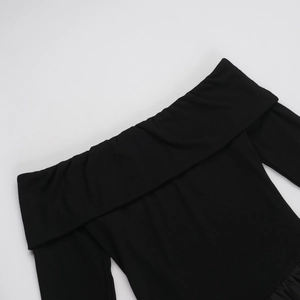 Detailed close-up of black ribbed fabric texture and off-shoulder neckline design