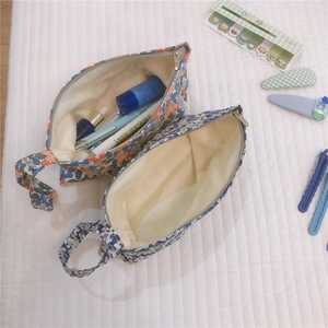 Dettaglio pochette in cotone a fiori con spazio per cosmetici e articoli di cancelleria