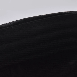 Detailed close-up showing precision stitching on black fabric of the baseball cap
