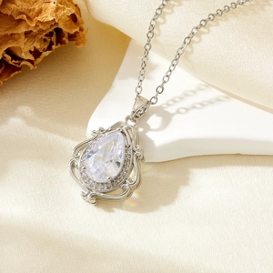 Close-up of a pear-shaped cubic zirconia pendant with baroque hollowed silver metal work