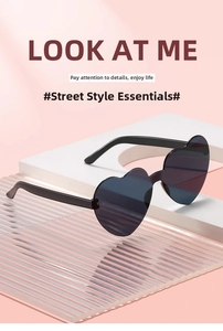 Detail of trendy heart-shaped sunglasses with black glossy frames and dark lenses