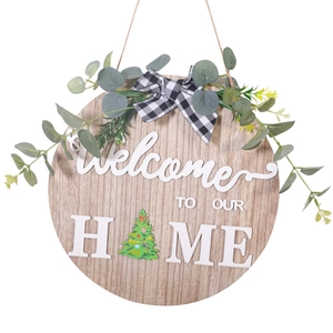 Round wooden welcome sign with buffalo plaid bow and greenery for home wall decor