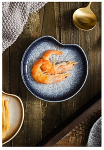 Japanese style ceramic appetizer plate with blue rim and white crackle glaze texture