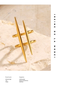 Detail of minimalist gold-plated stainless steel ring with vertical spike design on stone