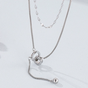 Detail of silver double layer necklace featuring interlocking rings and crystal pavé pendant