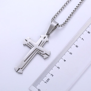 Detailed view of silver stainless steel cross pendant with ruler showing 5.5cm size