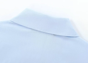 Detail of light blue poplin shirt collar featuring precise stitching and high-quality fabric