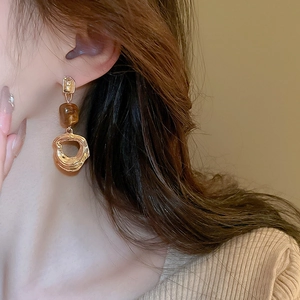 Luxurious gold-plated drop earrings with amber resin beads and textured metal rings