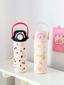 Detail of cute stainless steel thermos bottles with strawberry and floral prints