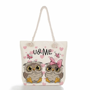 Detail of owl and heart print on beige linen tote bag with sturdy rope handles