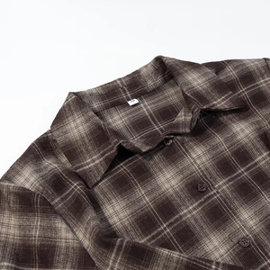 Close-up of flannel plaid shirt collar with soft texture and size S label detail