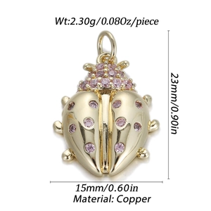 Detailed view of 23mm golden copper ladybug pendant with pink cubic zirconia inlay