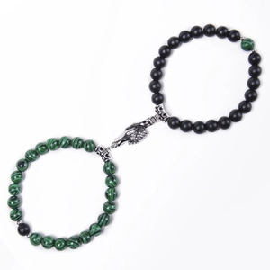 Detail of beaded couple bracelets with magnetic handshake clasp and green stone beads