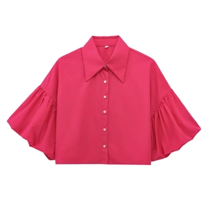 Fashionable rose red shirt with puff sleeves and white buttons on a clean white background